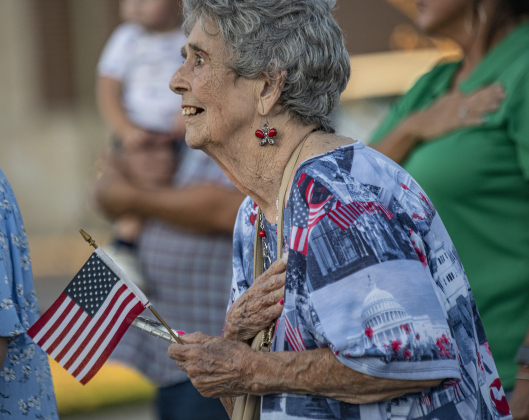 Irene Michna, 80, watches as the parade and Taylor Fire Department Honor Guard pass by her during the Patriot Day observance on Wednesday evening, September 11, 2024.   Patriot Day commemorates the events of September 11, 2001.    Photo by Andy Sharp.