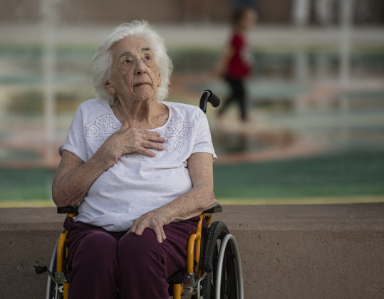 96-year-old Dolores Bilicki salutes for the raising of the flag by the Taylor Fire Department Honor Guard  during the Patriot Day observance at Heritage Square Park  on Wednesday evening, September 11, 2024. Her grandson, Justin Bilicki, is a member of the Honor Guard that posted the colors.    Patriot Day commemorates the events of September 11, 2001.    Photo by Andy Sharp.