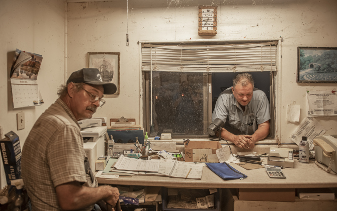 Waterloo Gin co-owners Clement Strmiska, left, and David Wollett, right, relax near day's end after picking up harvested cotton from area fields  on Friday, September 13, 2024.  The gin is  located on County Road 414 east of Taylor.     Photo by Andy Sharp.