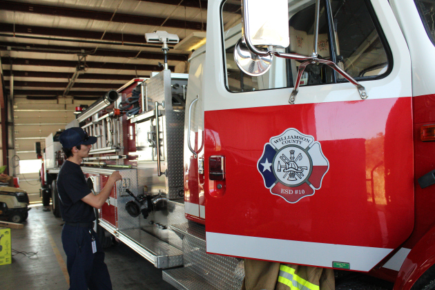 Firefighter Stephen Barnes gives a tour of one of the firetrucks at the ESD 10 station in  Coupland. Photo by Nalani Nuylan.