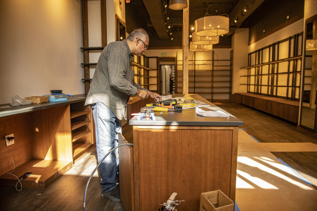 Hussain Khetani continues work around the front checkout area for what will soon be Tecovas  on Thursday, September 19, 2024.  Located on Main Street below the Williamson County Sun offices, Tecovas is scheduled for a soft opening on September 25, with formal opening on September 27. Photo by Andy Sharp.