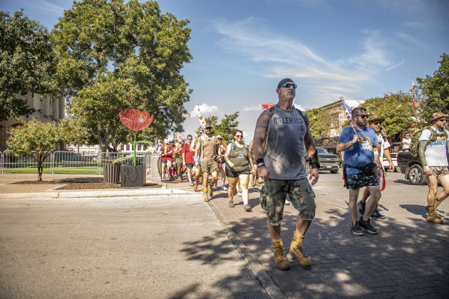 Irreverent Warriors walk along 7th Street on the Georgetown square as their group continued their 6.1 mile Silkies Hike through Georgetown on Saturday, September 21, 2024.
