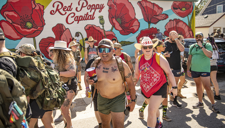 Irreverent Warriors group members continued their 6.1 mile Silkies Hike through Georgetown after a brief stop in front of the mural at Gus's Drugs  on Saturday, September 21, 2024.