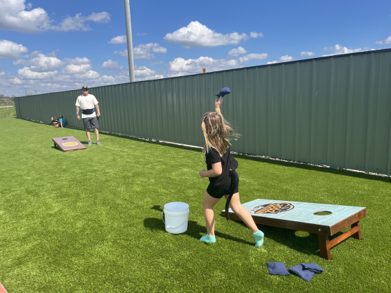 Jeff Morton and Ava Morton playing cornhole.