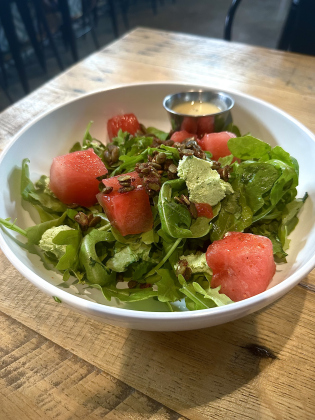 Spicy Watermelon Salad with wild arugula, chile-salted watermelon, spiced pepitas, jalapeño-mint goat cheese, and maple-cider vinaigrette