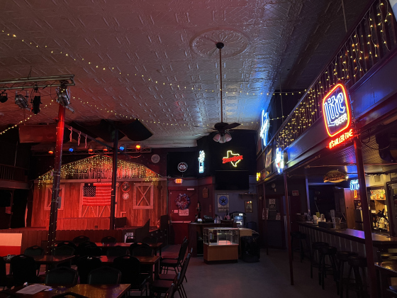 The dance hall has ceiling tiles original to the 1900s building and features plenty of neon signs, providing an authentic dancehall feel. Photo by Abbey Archer