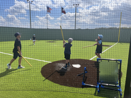 Boys play wiffle ball on the Biggs Filled Wiffle Ball field.