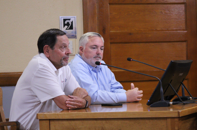 Dave Porter, executive director for the Wilco EDP (front), and Ben White, president and CEO of the Taylor Economic Development Corporation (back), answer questions about the tax agreement and Soulbrain. Photo by Nalani Nuylan.