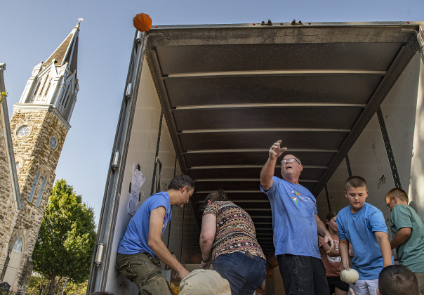 Kenny Bray, center (on truck) Youth Director  at First United Methodist Church in Georgetown was one of many on hand to help unload pumpkins at First United Methodist Church on Wednesday, October 9, 2024.  2,880 large pumpkins, plus many smaller versions were unloaded at the church.   The pumpkins were grown in New Mexico.   A second, but smaller batch of pumpkins will arrive from there on October 19th.   Sales continue through 5p.m. on October 31st.    Photo by Andy Sharp.