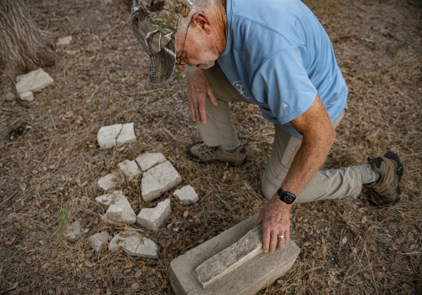 Joe Plunkett, with the Cemetery Restoration Volunteers, looks over broken piece of a gravestone  at the circa 1851 McFadin Cemetery on Tuesday, October 8, 2024. Plunkett and his group led the effort to restore this cemetery near the San Gabriel River in recent years.     Photo by Andy Sharp.