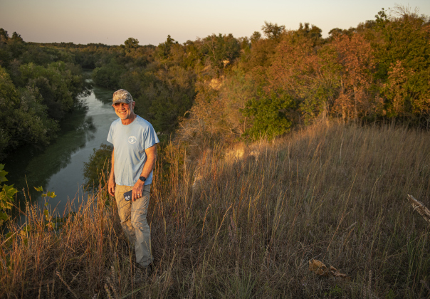Joe Plunkett, with the Cemetery Restoration Volunteers, enjoys a view of the San Gabriel River that flows near the circa 1851 McFadin Cemetery on Tuesday, October 8, 2024. Plunkett and his group led the effort to restore this cemetery near the San Gabriel River in recent years.     Photo by Andy Sharp.