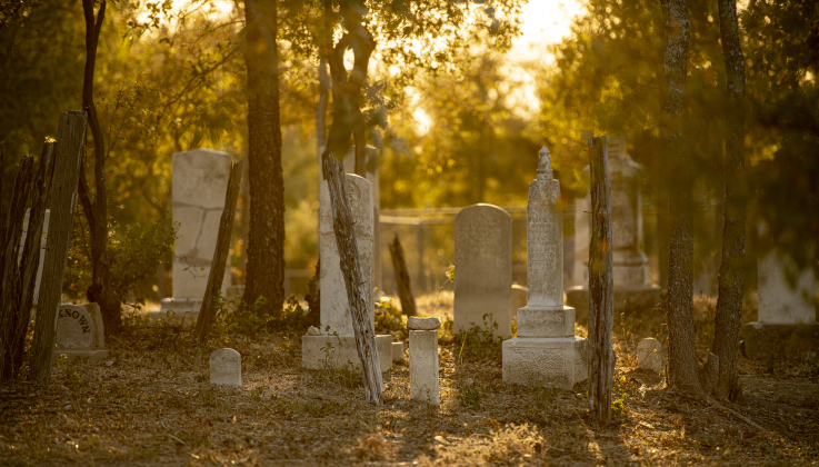 Late-day light encompasses a section  of the circa 1851 McFadin Cemetery on Tuesday, October 8, 2024. Joe Plunkett and his group, Cemetery Restoration Volunteers,  led the effort to restore this cemetery near the San Gabriel River in recent years.     Photo by Andy Sharp.