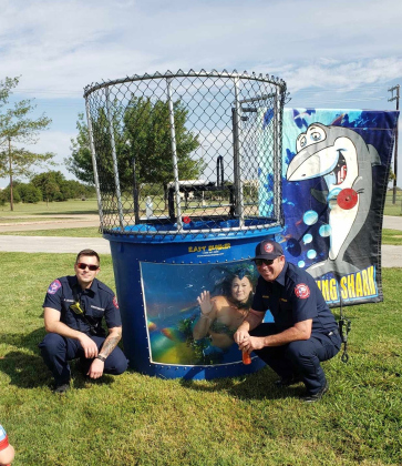 Mermaid Pearl in a dunk booth with Jarrell firefighters at the Hearts of Hope event for the Brooklyn Miller Foundation.