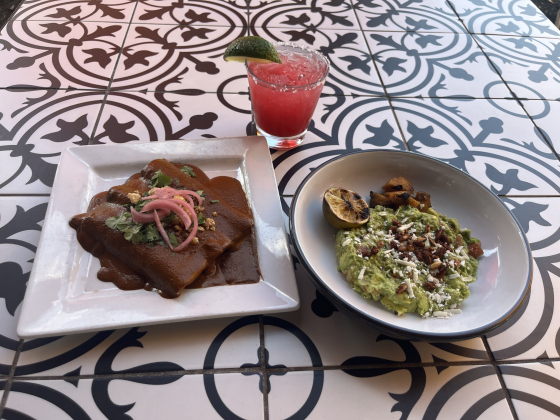 Duck mole enchiladas, with a prickly pear margarita and guacamole with grilled pineapples, pepitas and queso fresco.