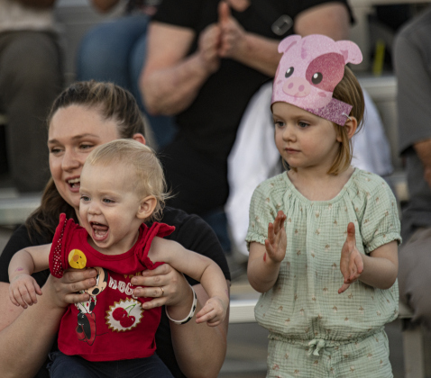 Shelby Morgan and her children Karlotta, 18-months, and Briana, 4, enjoyed the Swifty Swine pig races during the Williamson County Fair &amp; Rodeo opening night at the Williamson County Expo Center on Wednesday, October 23, 2024.  The fair and rodeo continues through Saturday, October 26th.   Photo by Andy Sharp.