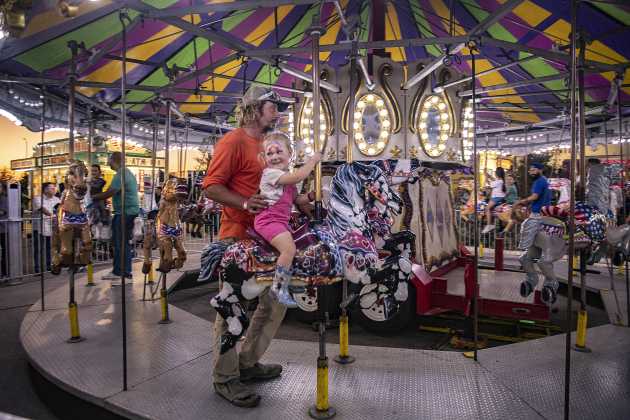 Adam Blundell and his daughter Wren, 2, had fun on an old-fashioned carousel ride during the Williamson County Fair &amp; Rodeo opening night at the Williamson County Expo Center on Wednesday, October 23, 2024.  The fair and rodeo continues through Saturday, October 26th.   Photo by Andy Sharp.