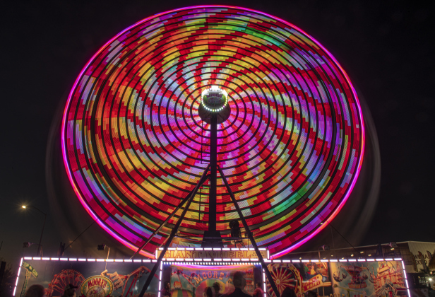 The midway's ferris wheel spins during the Williamson County Fair &amp; Rodeo opening night at the Williamson County Expo Center on Wednesday, October 23, 2024.  The fair and rodeo continues through Saturday, October 26th.   Photo by Andy Sharp.