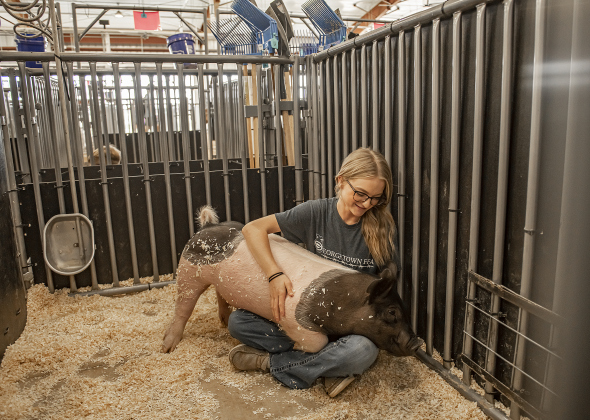 Georgetown High junior Addi Lane spends time with her pig named Oakley  during the Grand Opening of Georgetown High School's new Ag barn on Wednesday, September 25, 2024.   Photo by Andy Sharp.
