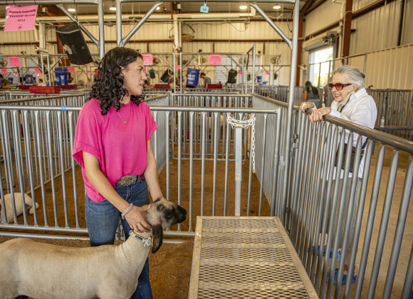 Georgetown High junior McKenna Melendez, with her sheep named Leonard, takes time to chat with her great-grandmother Jo Walker, 94,  right, during the Grand Opening of Georgetown High School's new Ag barn on Wednesday, September 25, 2024.   Photo by Andy Sharp.