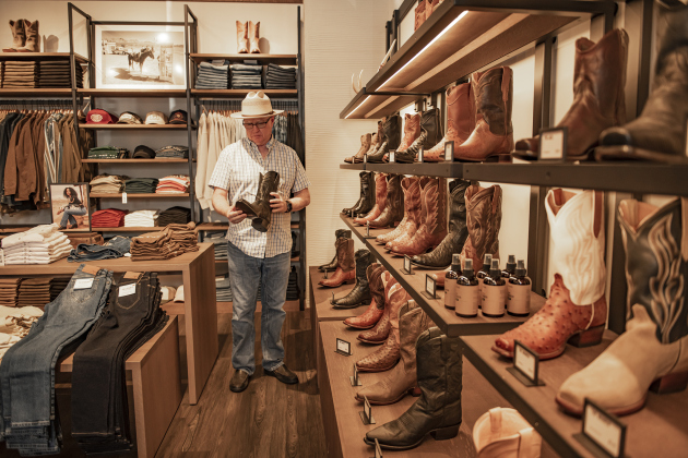 Weldon Munsey ponders a boot purchase  during Tecovas Grand Opening  on Friday, September 27, 2024.  The store is along Main Street, in the area under the Williamson County Sun offices.   Photo by Andy Sharp.