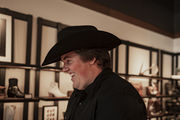 Staff member Drew Bell waits on a customer during Tecovas Grand Opening  on Friday, September 27, 2024. Bell is also a senior at Southwestern University.   The store is along Main Street, in the area under the Williamson County Sun offices.   Photo by Andy Sharp.
