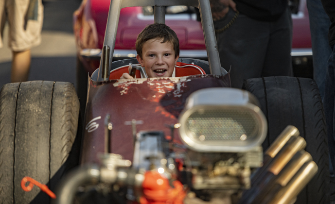 9-year-old Alex Dill enjoys sitting in the driver's seat of a front-engine dragster owned by Oscar Vera during Taylor's Main Street Car Show on Saturday, October 26, 2024.    Photo by Andy Sharp.