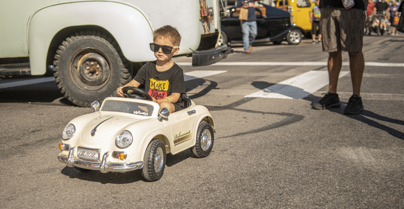 3-year-old Sterling Caraballo navigates his tiny car along Main Street during Taylor's Main Street Car Show on Saturday, October 26, 2024.    Photo by Andy Sharp.