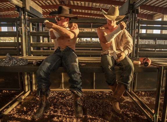 Bareback Riding participants Connor Griffith, left, from Merryville, Louisiana, and Zach Hibler, from Wheeler, Texas, get prepared for competition at the Williamson County Fair Rodeo  on Friday, October 25, 2024.   Photo by Andy Sharp.