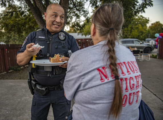 Georgetown police officer Cesar Salinas visits with Marion Goforth during a National Night Out event held on Tuesday, October 1, 2024 at the Georgetown Housing Authority Activity Learning Center on West 18th Street.    Photo by Andy Sharp.