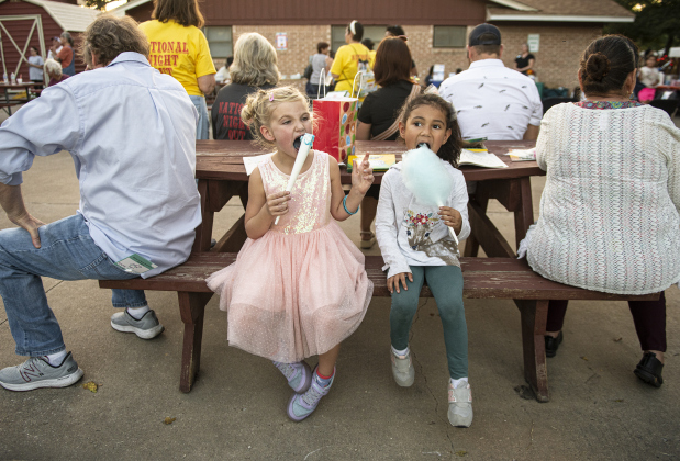 Friends Heidi Jo Brennan, left, and Leila Sanchez, right, both 6, enjoyed their cotton candy treats during a National Night Out event held on Tuesday, October 1, 2024 at the Georgetown Housing Authority Activity Learning Center on West 18th Street.    Photo by Andy Sharp.