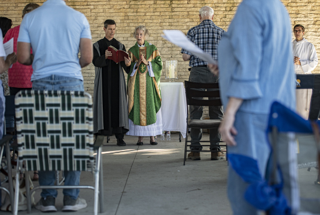 The Reverend Mary Ann Huston, assisted at left by John Haynes,  conducts a Blessing of the Animals service for Grace Episcopal Church,  held at San Gabriel Park on Sunday, October 6, 2024.   Photo by Andy Sharp.