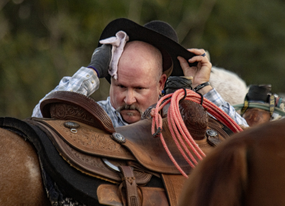 Barry Taylor cools off after competing in Team Roping at  the 31st Annual Clayman Rodeo on Saturday, October 5, 2024.  Held at Windsong Farm, the rodeo was founded by Kelly and Jim Bob Clayman.    Photo by Andy Sharp.
