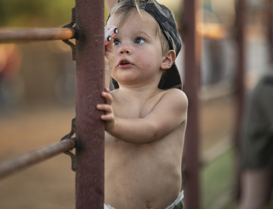 2-year-old rodeo attendee Rhodes Matthew Guinn decided the afternoon heat was too much for wearing a shirt at the 31st Annual Clayman Rodeo on Saturday, October 5, 2024.  Held at Windsong Farm, the rodeo was founded by Kelly and Jim Bob Clayman.    Photo by Andy Sharp.