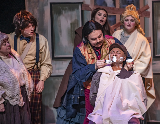 Isaac Howell, as Adolfo Pirelli, administers a shave to ensemble cast member Theron Howard during a Thursday, October 3, 2024 dress rehearsal of "Sweeney Todd," playing on the Springer Stage at the Georgetown Palace through November 3rd.    Photo by Andy Sharp.