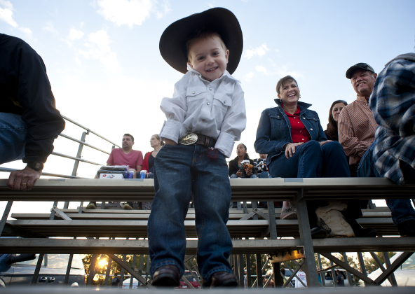 3-year-old Caden Fawver, wearing his big hat, jeans and boots, is all decked out at the 20th Annual Clayman Rodeo at Windsong Farm on Saturday, October 5, 2013.