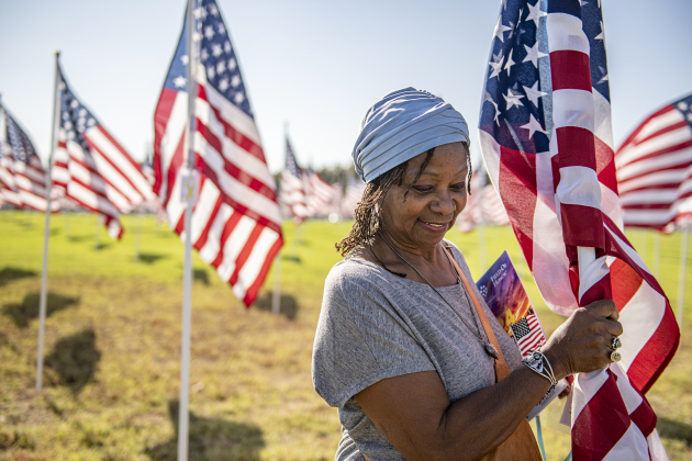 Bonita Brant posts a flag honoring several family members who have served in the military on Saturday, November 9, 2024, the official opening day of the Field of Honor.   Sponsored by the Rotary Club of Georgetown, the Field of Honor includes 2,000 American flags covering ten acres in San Gabriel Park.  With events throughout the week, the flags will fly here until November 17th.   Photo by Andy Sharp.