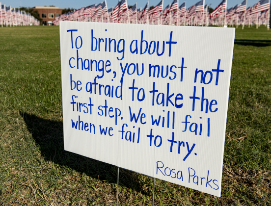 A sign with a quote by Civil Rights activist Rosa Parks was adjacent to the field of flags  on Saturday, November 9, 2024, the official opening day of the Field of Honor.   Sponsored by the Rotary Club of Georgetown, the Field of Honor includes 2,000 American flags covering ten acres in San Gabriel Park.  With events throughout the week, the flags will fly here until November 17th.   Photo by Andy Sharp.