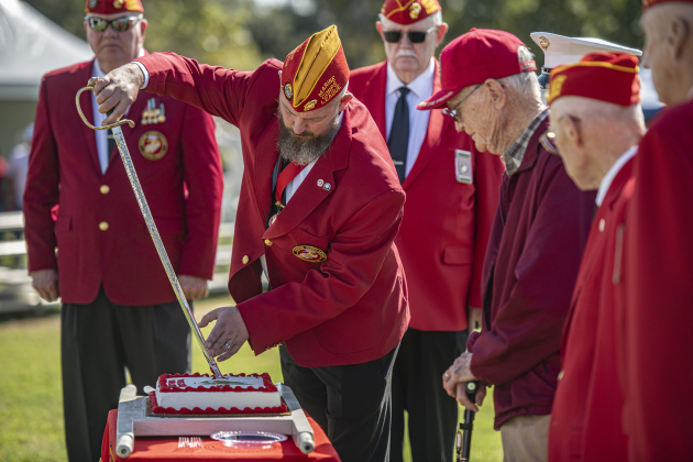 Marine Corps League Commandant Gus Kawell uses a ceremonial sword to cut a cake commemorating the 249th birthday of the Marine Corps ( November 10th) on Saturday, November 9, 2024, the official opening day of the Field of Honor.   Sponsored by the Rotary Club of Georgetown, the Field of Honor includes 2,000 American flags covering ten acres in San Gabriel Park.  With events throughout the week, the flags will fly here until November 17th.   Photo by Andy Sharp.