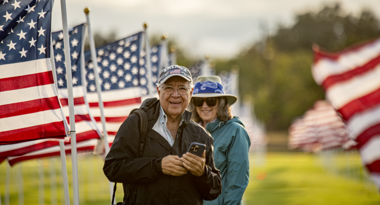 David Valdez and his wife Sarah spend time at the Georgetown Field of Honor on  Friday, November 8, 2024. Valdez, a Sun City resident, was the personal photographer for President George Herbert Walker Bush.    Sponsored by the Rotary Club of Georgetown, the Field of Honor includes 2,000 American flags covering ten acres in San Gabriel Park.  With events throughout the week, the flags will fly here until November 17th.   Photo by Andy Sharp.