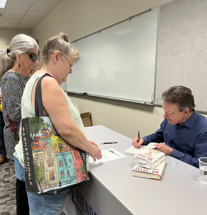 Mr. Wright signed four copies of Mr. Texas for an enthusiastic reader. Photo by Abbey Archer