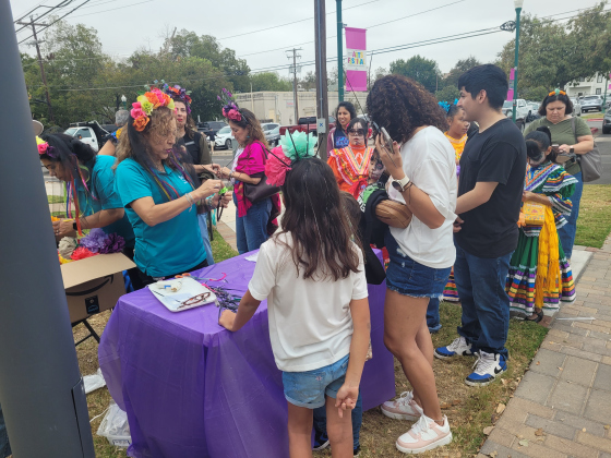 Volunteers from the Georgetown Project help kids make Day of the Dead headpieces.