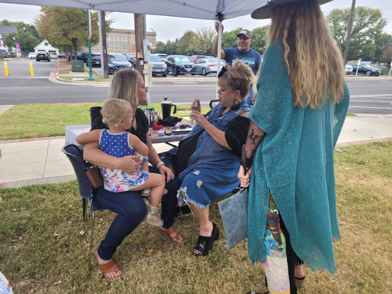 Residents wait in line to get their face painted like a Day of the Dead Skeleton.