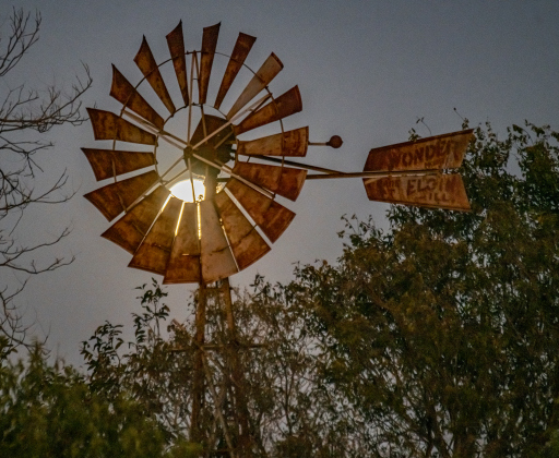 A full moon, also called a Beaver Moon, rises over a windmill along County Road 345 on Friday, November 15, 2024.   Photo by Andy Sharp.