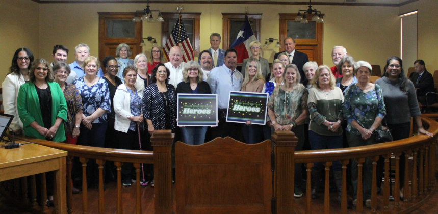  Election judges and clerks join Williamson County Party Chairs in the well of the Commissioners Courtroom. They were honored as election heroes. Photo courtesy of Williamson County.