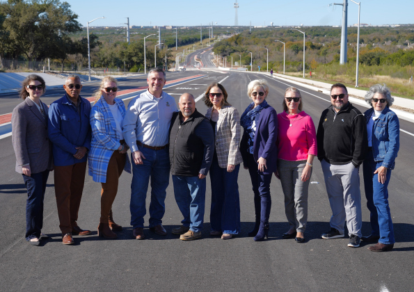 Wlico and Cedar Park officials celebrate New Hope Drive, a new road funded through city and county transportation bonds. Cedar Park Mayor Jim Penniman-Morin, center, stands on the road with Commissioners Valerie Covey, center right in blue, Cynthia Long, in pink, Terry Cook, far right, and others. Photos courtesy of the City of Cedar Park.