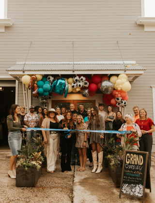 The ribbon cutting of Blue Sage Clothiers and Western Blonde Salon took place October 25, 2023. Shalene Scarborough, owner of Western Blonde Salon is holding the scissors. Kim Cauble is to her left. Photo courtesy of Alexis Fernardez