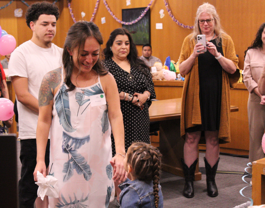 Adoptive mother Anna Marie Stanley twirls Reble Jo as she gives her testimony to Judge McMaster.