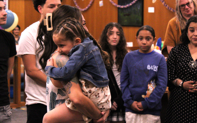 Four-year-old Rebel Jo hugs her adoptive mother, Anna Marie Stanley, as they stand before Judge John McMaster, County Court at Law Four.