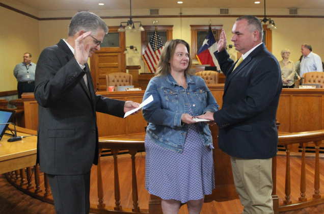 Ron Cunningham, right, gets sworn in as the Interim Fire Marshal for Williamson County during a meeting October 29. He was joined by his wife, pictured center.  Photo courtesy of Williamson County.