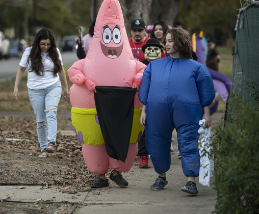 Carlos Rodriguez,16, left, as Patrick from Sponge Bob, is joined by friend Robert Calderon, 15, dressed as The Big Blue Thing,  during  Halloween night along Main Street  on Thursday, October 31, 2024.   Photo by Andy Sharp.